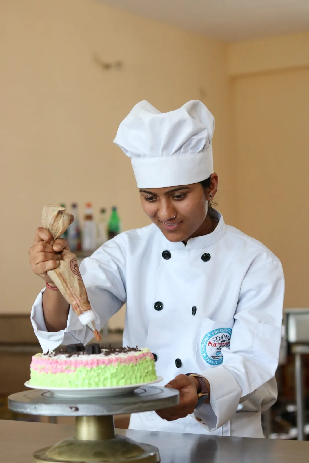 Hotel management student decorating a cake at PGI Pithoragarh